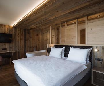 Double Room Lifestyle with Reclaimed Wood Furnishings and Freestanding Bathtub